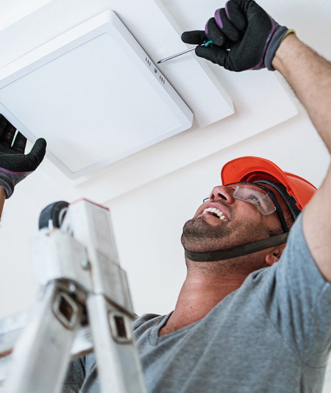 A happy man providing electrical services in Brampton